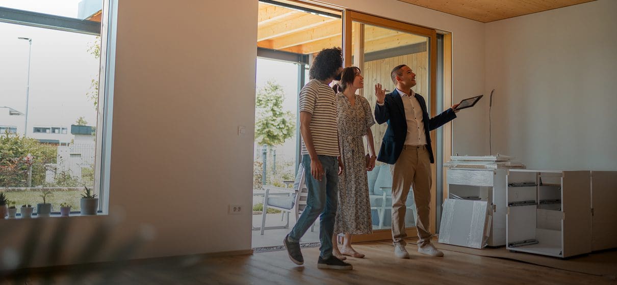 Real estate agent showing couple a house.