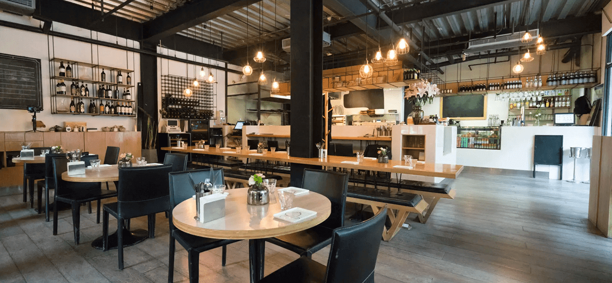 Modern restaurant interior with wooden tables.