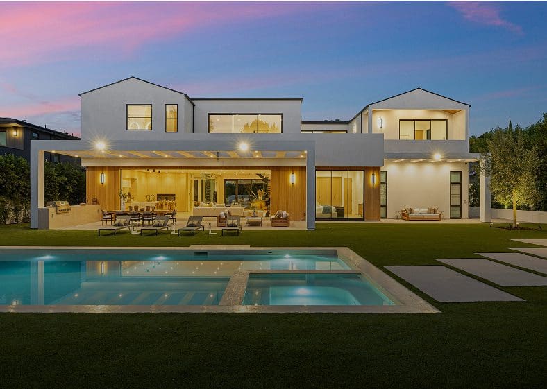 Modern house with pool at sunset.