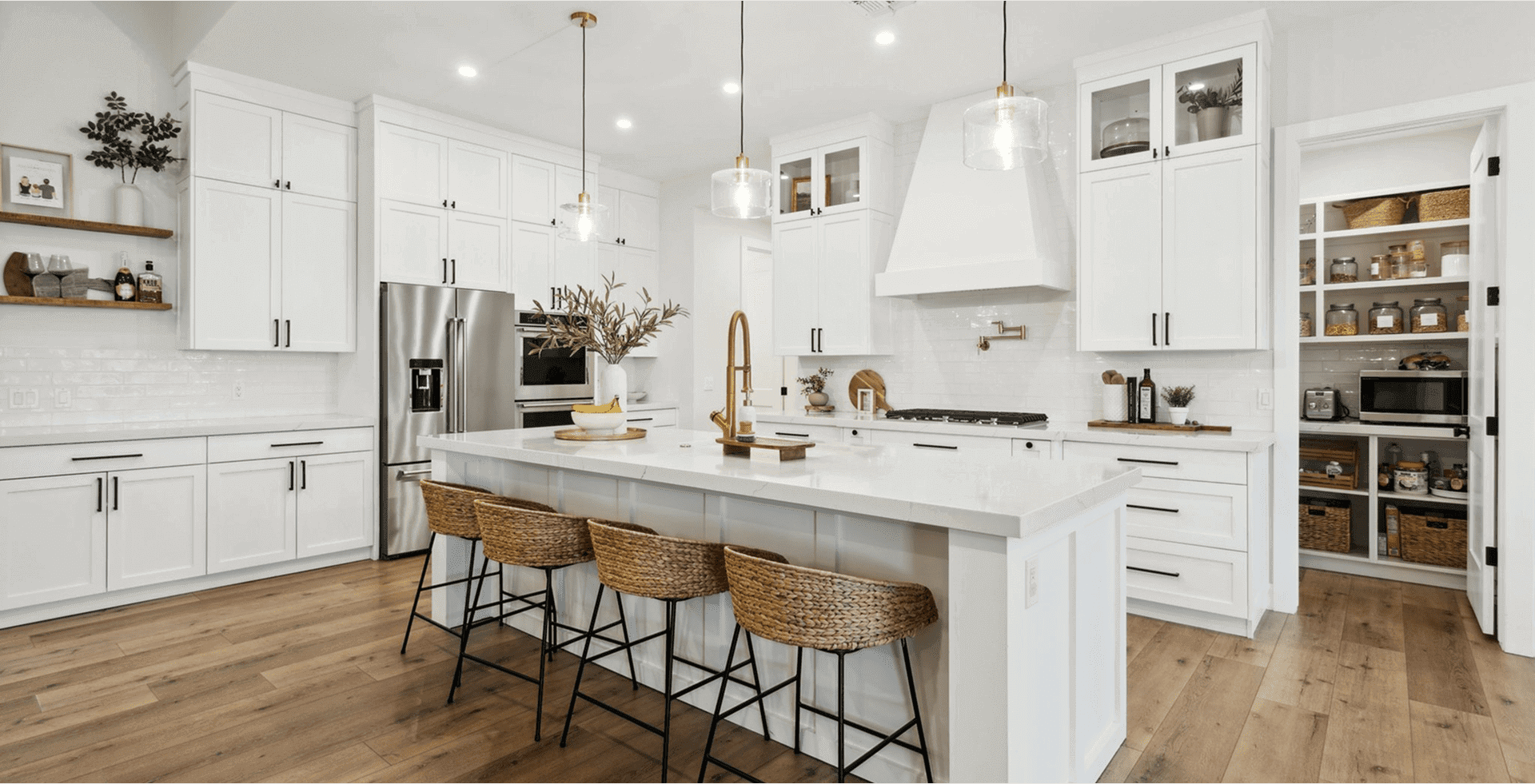 Modern kitchen with island and pantry shelves.