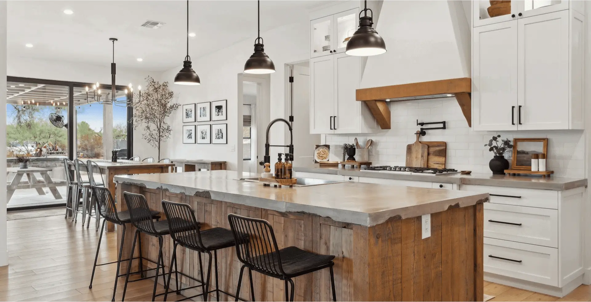 Modern kitchen with island and bar stools.